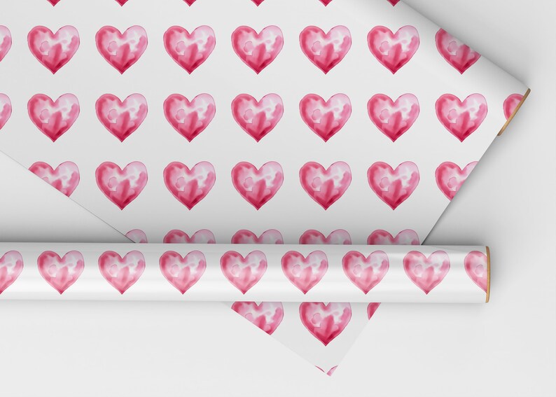 May include: Pink watercolor hearts on a white background. This wrapping paper features a repeating pattern of hearts.