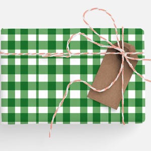 May include: A green and white gingham gift box tied with twine and a brown gift tag.