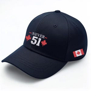May include: A navy blue baseball cap with a white embroidered "NEVER 51" and two red maple leaf designs. The cap also features a small Canadian flag patch on the side.