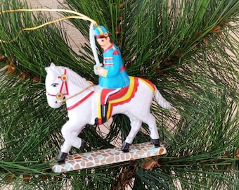Vintage Christmas tree decorations. Tin soldier on horseback. Antique Christmas decor from the 50s. Christmas gift.