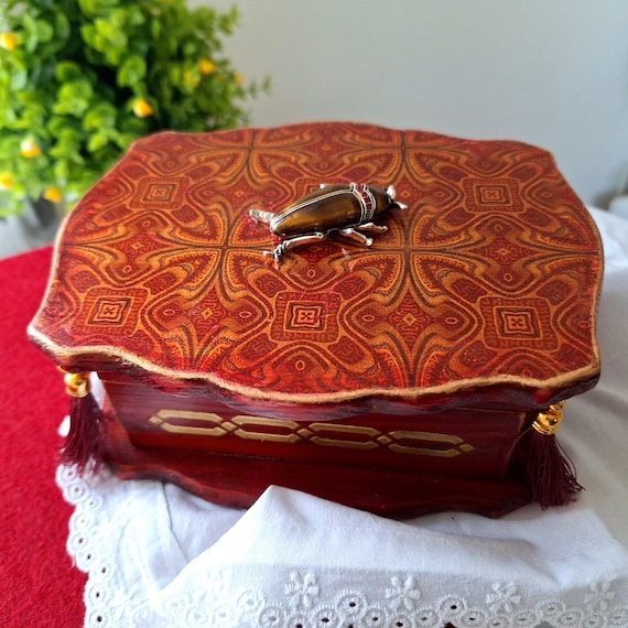 Deep burgundy hand-crafted wooden jewelry box with vintage joinery — the kind of piece that looks like it came from a European antique market.