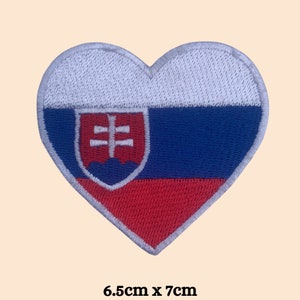 May include: An embroidered heart-shaped patch featuring the Slovakian flag. The flag is white, blue, and red with the Slovakian coat of arms in the centre. The patch measures 6.5 cm by 7 cm.
