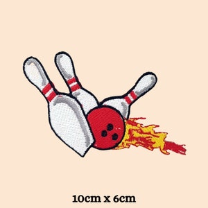 May include: An embroidered patch of three red and white bowling pins with a red bowling ball on fire. The patch is 10 cm by 6 cm.