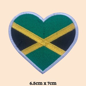May include: A heart-shaped embroidered patch featuring the Jamaican flag colors: green, yellow, and black. The patch is 6.5 cm by 7 cm.