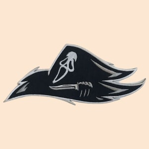 May include: Black and white embroidered patch of a pirate flag with a skull and crossbones design. The skull is holding a knife in its hand.