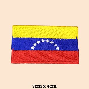 Könnte beinhalten: Gestickter Aufnäher mit der Flagge von Venezuela. Der rechteckige Aufnäher hat horizontale Streifen in Gelb, Blau und Rot, mit einem weißen Sternenbogen im blauen Streifen. Der Aufnäher misst 7 cm x 4 cm.