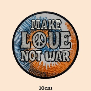 May include: A round, embroidered patch with a tie-dye design in blue and orange. The patch features a white peace sign and the text "Make Love Not War" in white.