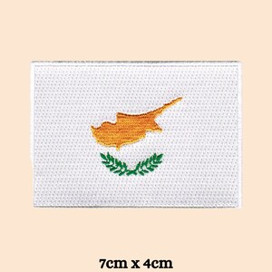 May include: White embroidered patch with the flag of Cyprus. The flag features a yellow outline of the island of Cyprus and a green olive branch wreath. The patch measures 7 inches by 4 inches.