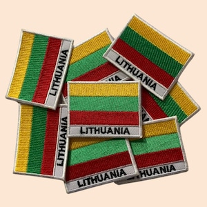 May include: A pile of embroidered iron-on patches featuring the Lithuanian flag. Each patch has the words "Lithuania" printed below the flag.
