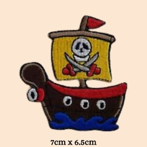 May include: A brown pirate ship with a yellow sail featuring a skull and crossbones. The ship is 7 cm by 6.5 cm.
