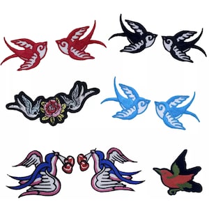 May include: A selection of embroidered bird patches in various colours. Designs include red, black, and blue swallows, some with floral accents or holding cherries. Suitable for clothing or craft projects.