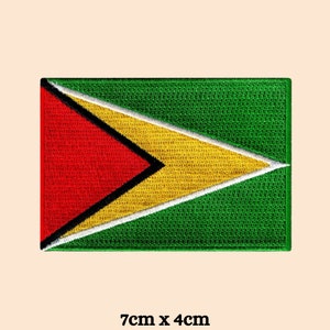 May include: An embroidered patch of the flag of Guyana. The flag is green with a yellow triangle with a red triangle inside. The patch is 7 cm by 4 cm.