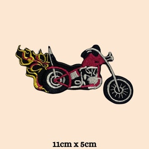May include: Embroidered iron-on patch of a red motorcycle with flames, 11cm by 5cm.