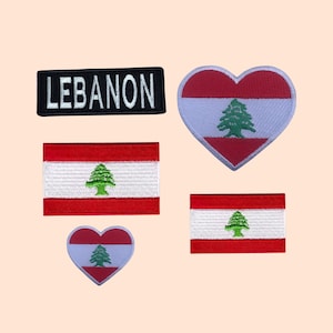 May include: Four embroidered patches featuring the Lebanese flag. One patch is a rectangle with the flag, another is a heart-shaped patch, and two are rectangular patches with the flag and the word "LEBANON" in white text on a black background.
