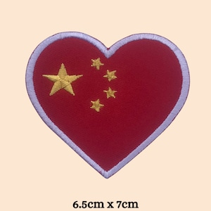 May include: Red heart-shaped patch with the Chinese flag embroidered on it. The flag features a large yellow star and four smaller yellow stars in a semi-circle. The patch measures 6.5 inches by 7 inches.