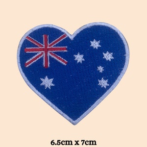 May include: A heart-shaped patch featuring the Australian flag. The flag is blue with a white Southern Cross constellation and a red Union Jack in the top left corner. The patch measures 6.5cm by 7cm.