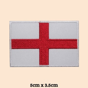 May include: A white embroidered patch with a red cross, representing the flag of England. The patch measures 5cm by 3.5cm.