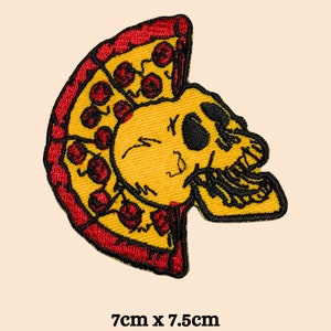 May include: A yellow skull with a red and yellow pizza slice in its mouth. The pizza has red pepperoni. The patch is 7cm by 7.5cm.