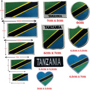 May include: A collection of embroidered patches featuring the flag of Tanzania in various shapes and sizes, including rectangles, circles, shields, and hearts. Some patches include the text Tanzania. Dimensions range from 3 cm to 18 cm in width.