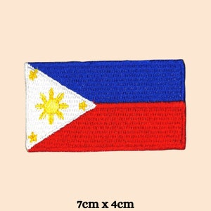 May include: Embroidered patch of the Philippine flag. The flag is red, white and blue with a yellow sun and stars. The patch is 7cm by 4cm.