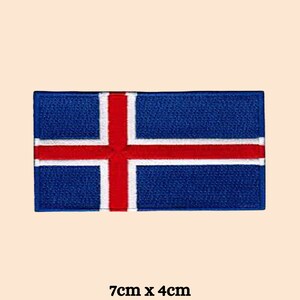 May include: An embroidered patch featuring the flag of Iceland, with a blue background and a red cross. The patch is 7cm by 4cm.