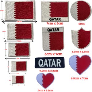 May include: A collection of embroidered patches featuring the Qatar flag in various shapes and sizes, including rectangles, circles, shields, and hearts. Some patches include the text QATAR, with dimensions ranging from 3 cm to 18 cm wide.