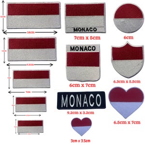 May include: A collection of embroidered patches featuring the red and white flag of Monaco in various shapes including rectangles, circles, shields, and hearts. Several patches include the text MONACO in black or white embroidery with visible metric dimensions.