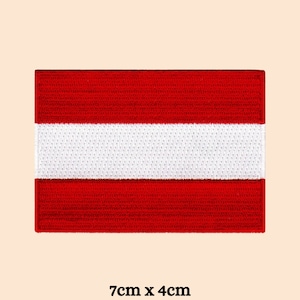 May include: Red and white embroidered patch of the Austrian flag. The flag is 7cm by 4cm.