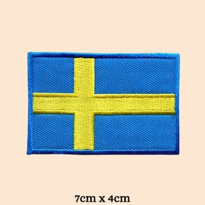 May include: An embroidered patch of the Swedish flag, blue and yellow. The flag measures 7cm by 4cm.