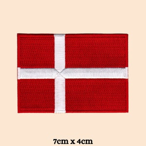 May include: Red and white embroidered patch of the Danish flag. The flag is 7 inches by 4 inches.