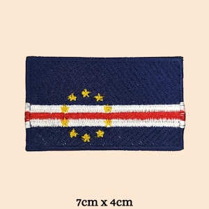 May include: Embroidered patch of the flag of Cape Verde. The flag is blue with a white stripe and a red stripe in the center. There are ten yellow stars in a circle in the upper left corner. The patch is 7 cm by 4 cm.