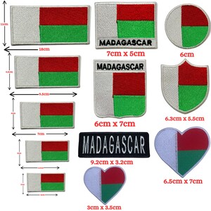 May include: A collection of embroidered patches featuring the Madagascar flag in various shapes and sizes, including rectangles, circles, shields, and hearts. Some patches include the text MADAGASCAR. Dimensions range from 3 cm to 18 cm.