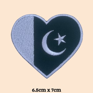 May include: A heart-shaped embroidered patch with the flag of Pakistan. The patch is green and white with a white crescent moon and star in the center. The patch measures 6.5 inches by 7 inches.