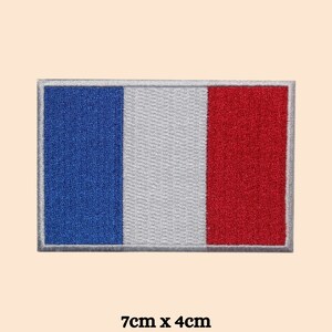 May include: Embroidered French flag patch in blue, white, and red with a grey border. The patch measures 7 cm by 4 cm.