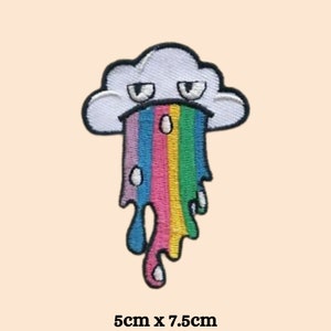 May include: A white cloud with a frowning face is vomiting a rainbow. The rainbow is dripping with colorful drops. The patch is 5 inches by 7.5 inches.