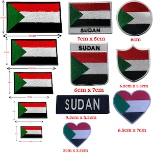 May include: A collection of embroidered patches featuring the Sudan flag in various shapes and sizes, including rectangular, circular, shield, and heart designs. Some patches include the text SUDAN. Dimensions range from 3cm to 18cm in width.