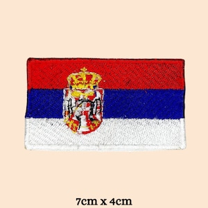 May include: Embroidered patch of the Serbian flag. The flag is red, blue, and white with the coat of arms in the center. The patch is 7 cm by 4 cm.