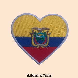 May include: Heart-shaped embroidered patch featuring the flag of Ecuador. The patch has a yellow top, blue center, and red bottom, with the Ecuadorian coat of arms in the center. The patch measures 6.5cm x 7cm.