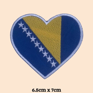 May include: A blue and yellow heart-shaped patch with white stars, representing the flag of Bosnia and Herzegovina. The patch measures 6.5 inches by 7 inches.