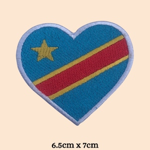 May include: A blue heart-shaped patch with a yellow star and red and yellow diagonal stripes. The patch is 6.5 inches by 7 inches.