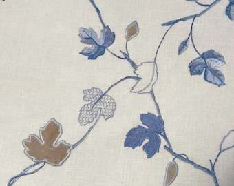 May include: A light beige fabric featuring an intricate embroidery pattern of winding vines with leaves in shades of blue, light blue, and tan. The design includes solid filled leaves, outlined leaf shapes, and leaves with a cross-hatch stitch.