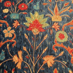 May include: A blue fabric with a repeating pattern of stylized flowers and leaves in shades of red, orange, yellow, and green. The fabric has a textured surface.