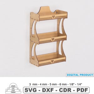 May include: A three-tiered wooden wall shelf with a light brown finish. The shelf has a decorative top and curved side supports. The image includes the text "DIGITAL PRODUCT" and "SVG - DXF - CDR - PDF".