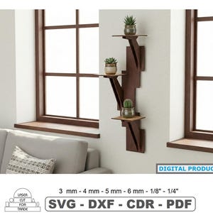May include: A dark brown wooden wall shelf with three tiers, each holding a small potted plant. The shelf is mounted on a white wall near a window. The text "DIGITAL PRODUCT" and "SVG - DXF - CDR - PDF" are visible.