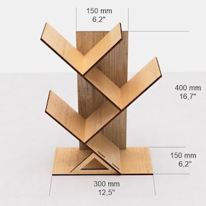May include: Wooden bookshelf with a tree-like design. It has five shelves and measures 12.5 inches wide, 16.7 inches tall, and 6.2 inches deep.