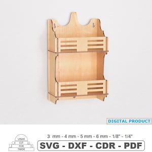 May include: A two-tiered, unfinished wooden wall shelf with a decorative top. The shelf has two horizontal compartments with slotted fronts. The text "DIGITAL PRODUCT" is visible. The shelf is designed for laser cutting and is available in SVG, DXF, CDR, and PDF formats.