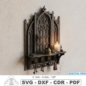 May include: A dark gray laser-cut wooden wall shelf featuring a gothic arch design with a central rose window motif. The shelf holds a brass inkwell with a quill and a white candle. Four metal hooks hang below, holding keys. Text: DIGITAL PRODUCT 3 mm - 4 mm - 1/8" SVG - DXF - CDR - PDF.