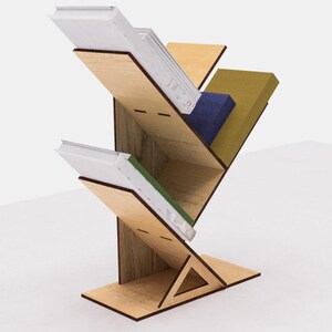 May include: A wooden bookshelf shaped like a tree with four shelves. The shelves are filled with books of different colors and sizes.