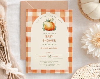 May include: Baby shower invitation with a pumpkin theme. The invitation features a smiling pumpkin illustration and the text "A Little Pumpkin Is On Its Way." The invitation is in a cream-colored arch with a plaid orange and white background.