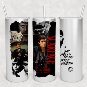 May include: Three stainless steel tumblers with a white background and a black and white collage of images of Al Pacino as Tony Montana from the movie Scarface. The tumbler on the right has the text "Say hello to my little friend" in black text.